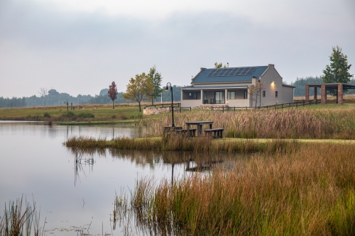 Lake View, eight‑sleeper self‑catering cottage at Blue Crane Farm in Dullstroom, nestled beside the trout dam—ideal for family getaways and peaceful nature retreats.